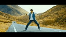 a man is dancing on the side of the road