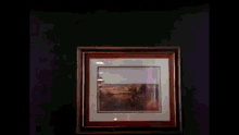 a man in a white suit and tie is dancing in front of a picture .