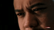 a close up of a man 's face with the word fuji on the bottom