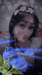 a girl with a flower crown on her head is surrounded by blue flowers and stars