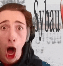 a man with a surprised look on his face is wearing headphones and the word sylvain is behind him