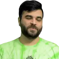 a man with a beard is wearing a green tie dye shirt with a dragon on it