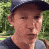a man wearing a hat that says tommy hilfiger on it