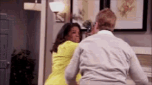 a man and a woman are dancing in a living room .