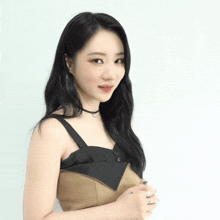 a woman wearing a choker and a black and brown top