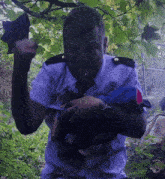 a man in a police uniform is holding a black object in his hands