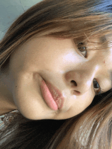 a close up of a woman 's face with a pink lipstick on her lips