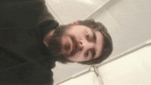 a man with a beard wearing a black sweatshirt