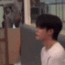 a blurry picture of a man sitting in a chair with his eyes closed .