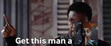 a man with a picture of a jester and the words " get this man a " on the bottom