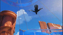 a bird is flying through the air in front of a building