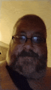 a man with a beard wearing glasses and a black tie