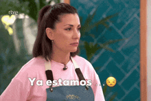 a woman wearing an apron says ya estamos in spanish