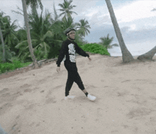 a person walking on a beach with a shirt that says ghost rider