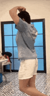 a person wearing a blue shirt with the word rock on the back