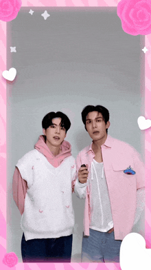 two men standing next to each other in a pink frame with hearts and roses