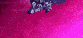 a robot is flying through a purple space with a purple background .