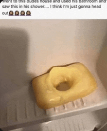 a yellow soap bar with a hole in the middle of it