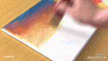 a painting is being painted on a canvas with the words made in animatica on the bottom