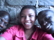 two men and a woman are posing for a picture