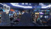 a man is standing in an arcade with a lot of games .