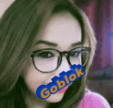 a woman wearing glasses has a goblok sticker on her face