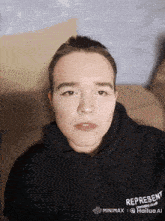 a man wearing a black hoodie that says represent
