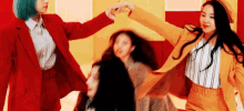 a group of women are standing next to each other in a room and holding hands .