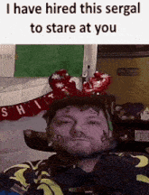 a man in a wheelchair is wearing a reindeer headband and has a tattoo on his face