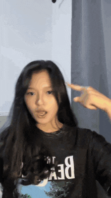 a girl wearing a black t-shirt that says dev on it