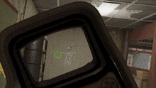 a close up of a rifle scope with a green circle on it