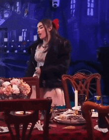 a woman in a fur coat is standing at a table with a candle on it