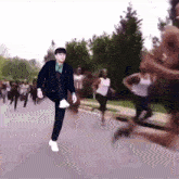a man in a suit and tie is running down a street