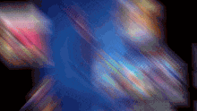 a blurry picture of a blue background with a rainbow of colors