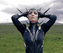 a woman with a helmet on her head holds her hands on her head