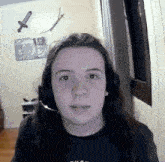 a girl with long hair wearing headphones and a microphone