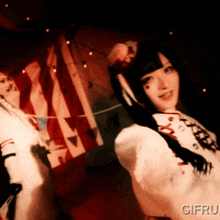 a woman in a white dress with the word gif on the bottom