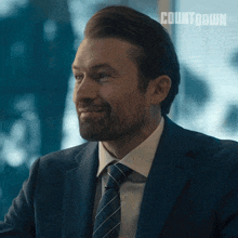 a man in a suit and tie with the word countdown on the bottom