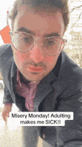 a man wearing glasses and a suit says misery monday ! adulting makes me sick !!