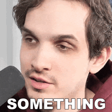 a close up of a man 's face with the word something written below it