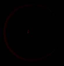 a red circle on a black background with a white border