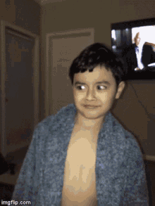 a young boy without a shirt is standing in front of a television with imgflip.com at the bottom of the screen