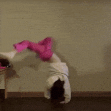 a little girl laying on the floor with her legs up