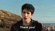 a young man says thank you in front of a disney logo