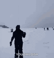 a woman is running through a snowy field while a group of people are skiing in the background .