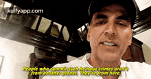 a man wearing a hat and a white shirt says " people who commit such heinous crimes aren 't from another planet