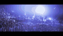 a crowd of people are watching a band on stage
