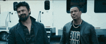 two men standing next to each other one of whom is wearing a shirt that says " big man "