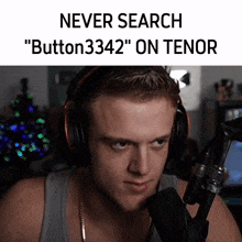 a man wearing headphones is sitting in front of a microphone with the words never search " button3342 " on tenor above him