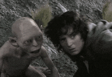 a man and a goblin are looking at each other in a black and white photo